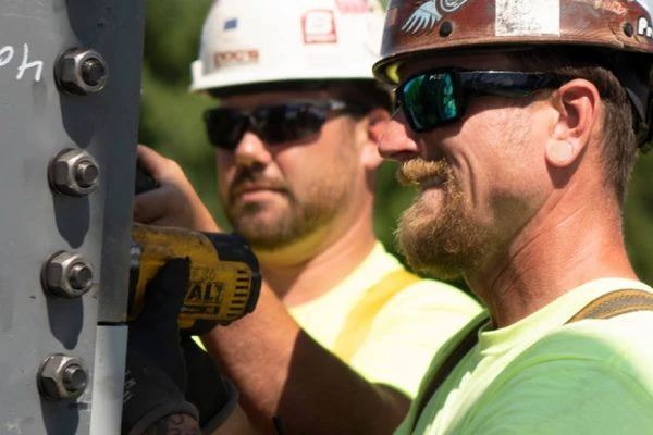 two men in construction hats working