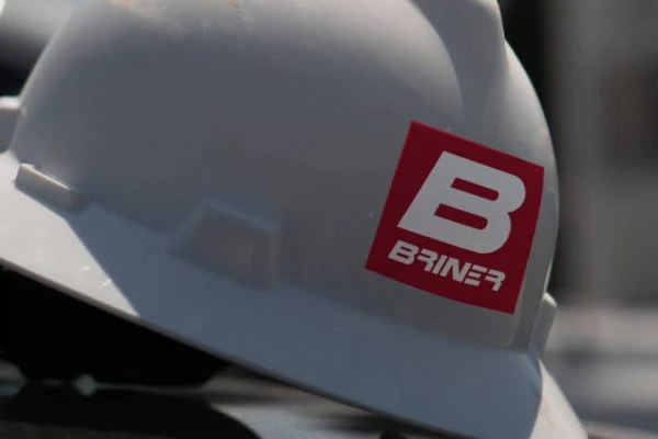 construction hat with Briner Building logo on it