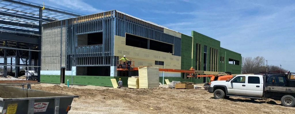 building during construction with truck parked outside