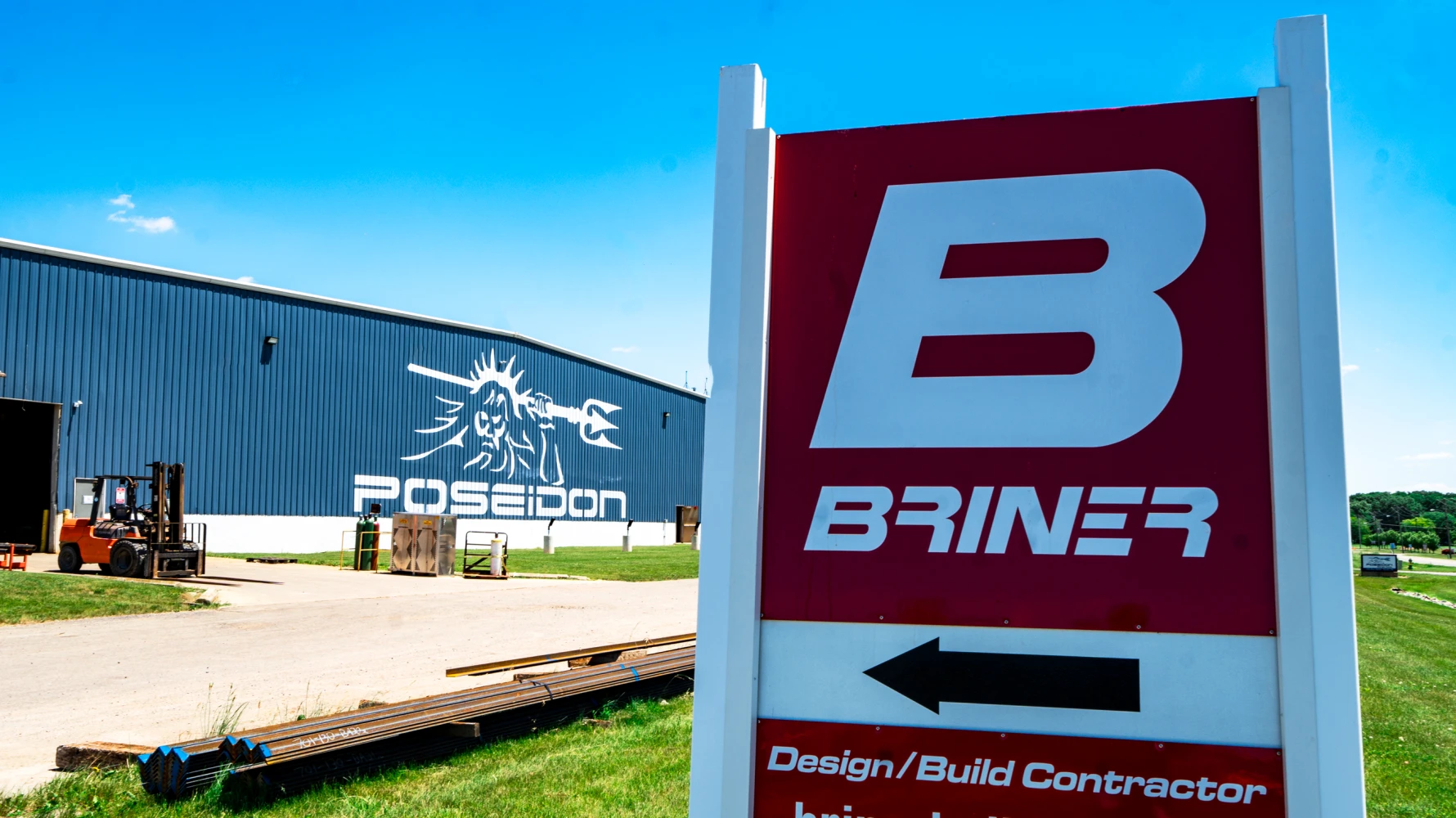 Briner Building logo on sign in front of Poseidon Barge building