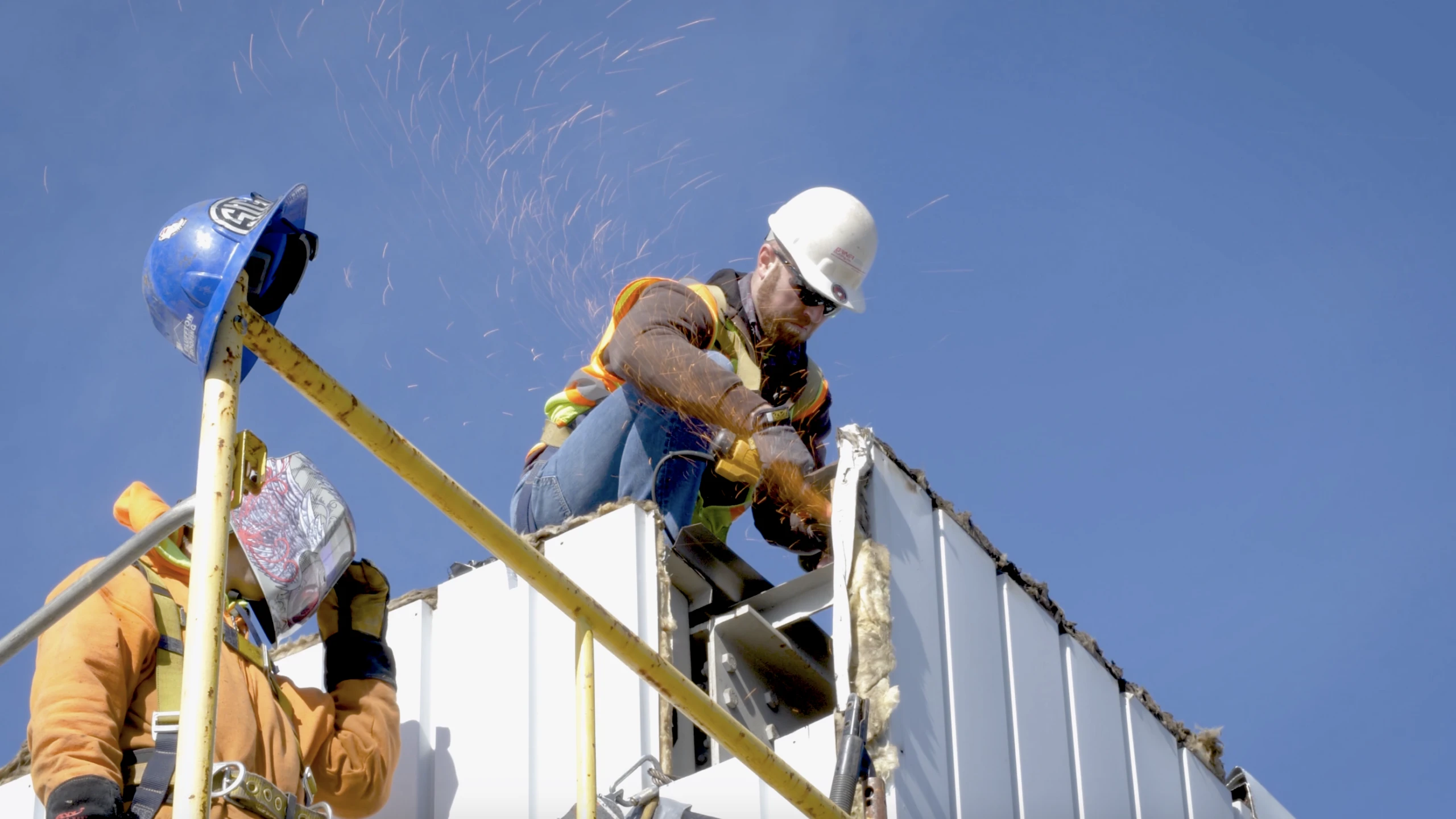 construction worker on rood of Almco Steel Products building