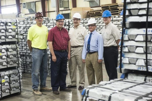 Briner Building team wearing construction hats inside of a warehouse