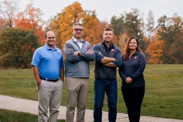 Briner Buidling team members standing outside with trees in background