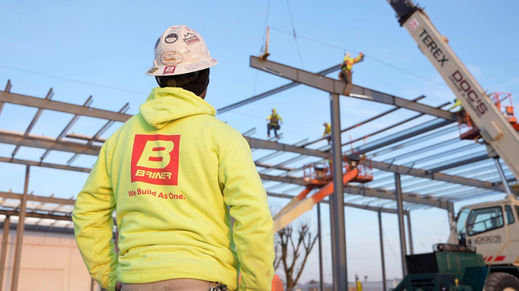 Briner employee looking towards steel framework of Wayne Metal