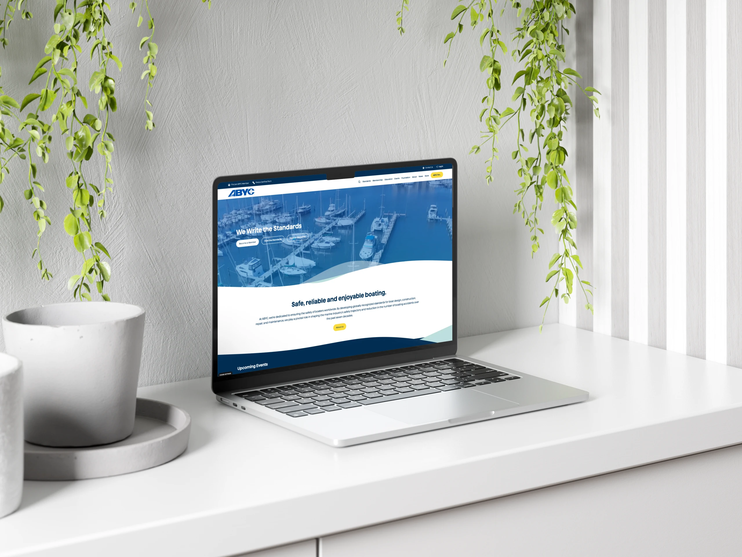 A mockup of a laptop showing the ABYC website