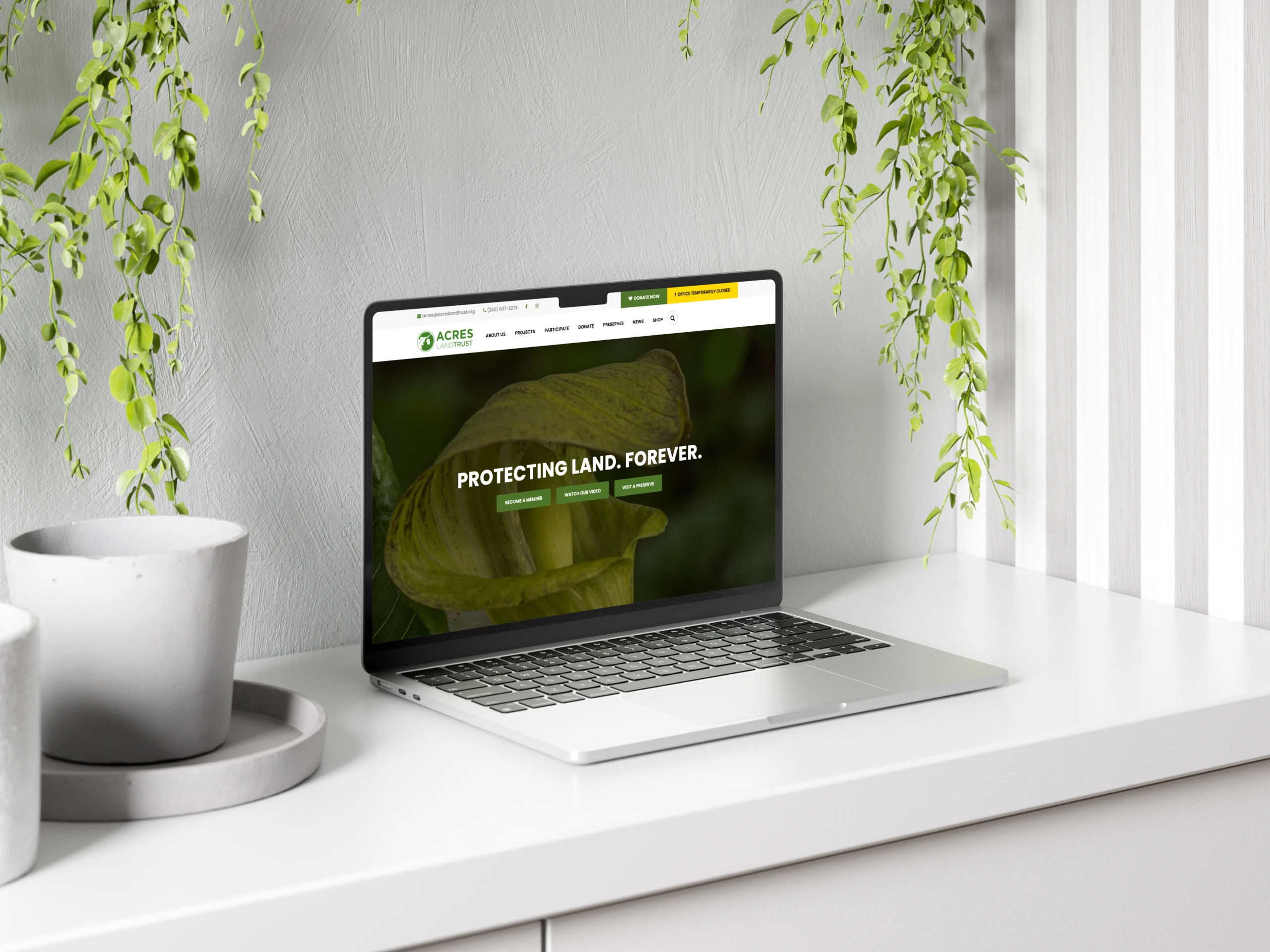 A mockup of a laptop showing the ACRES website