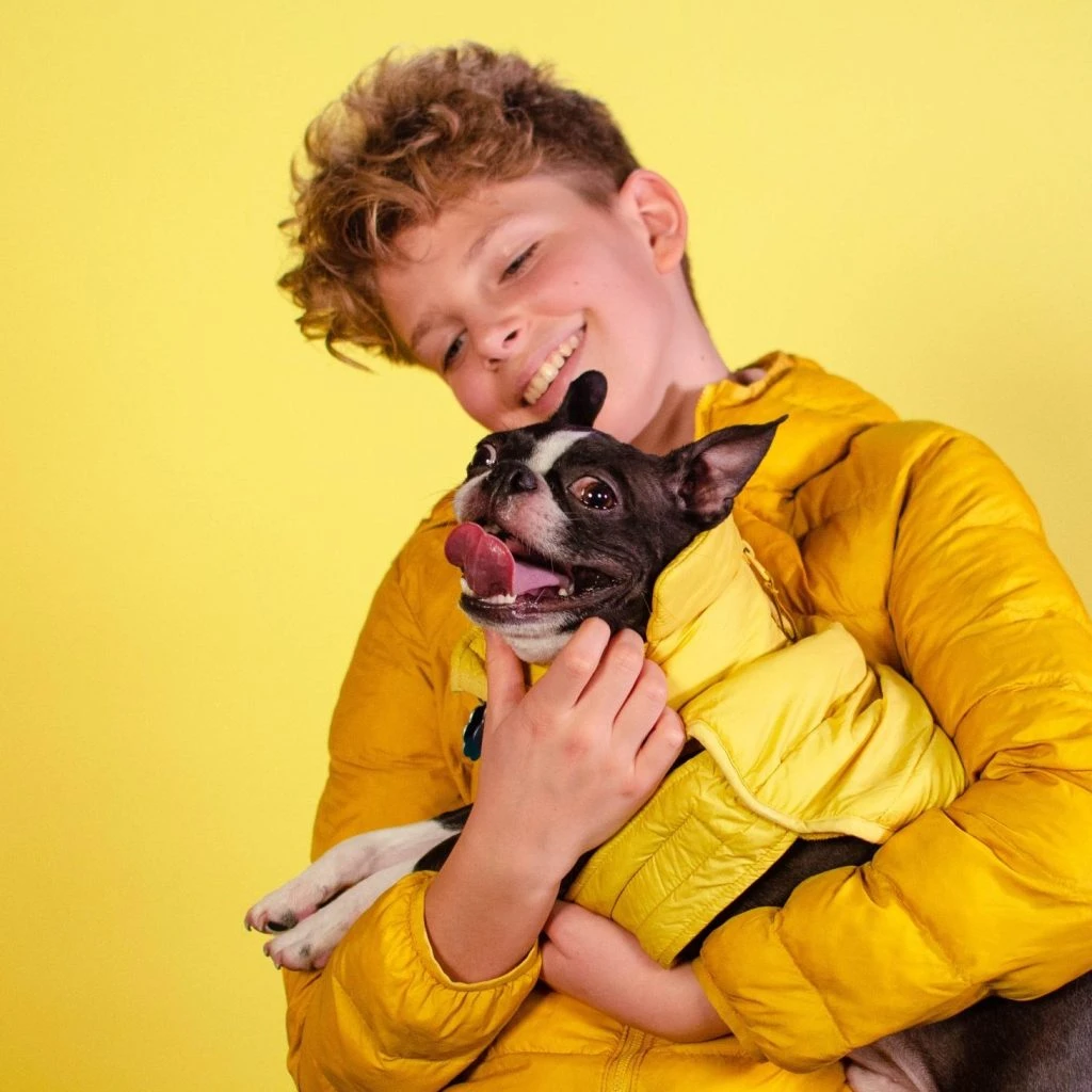 boy cuddling dog