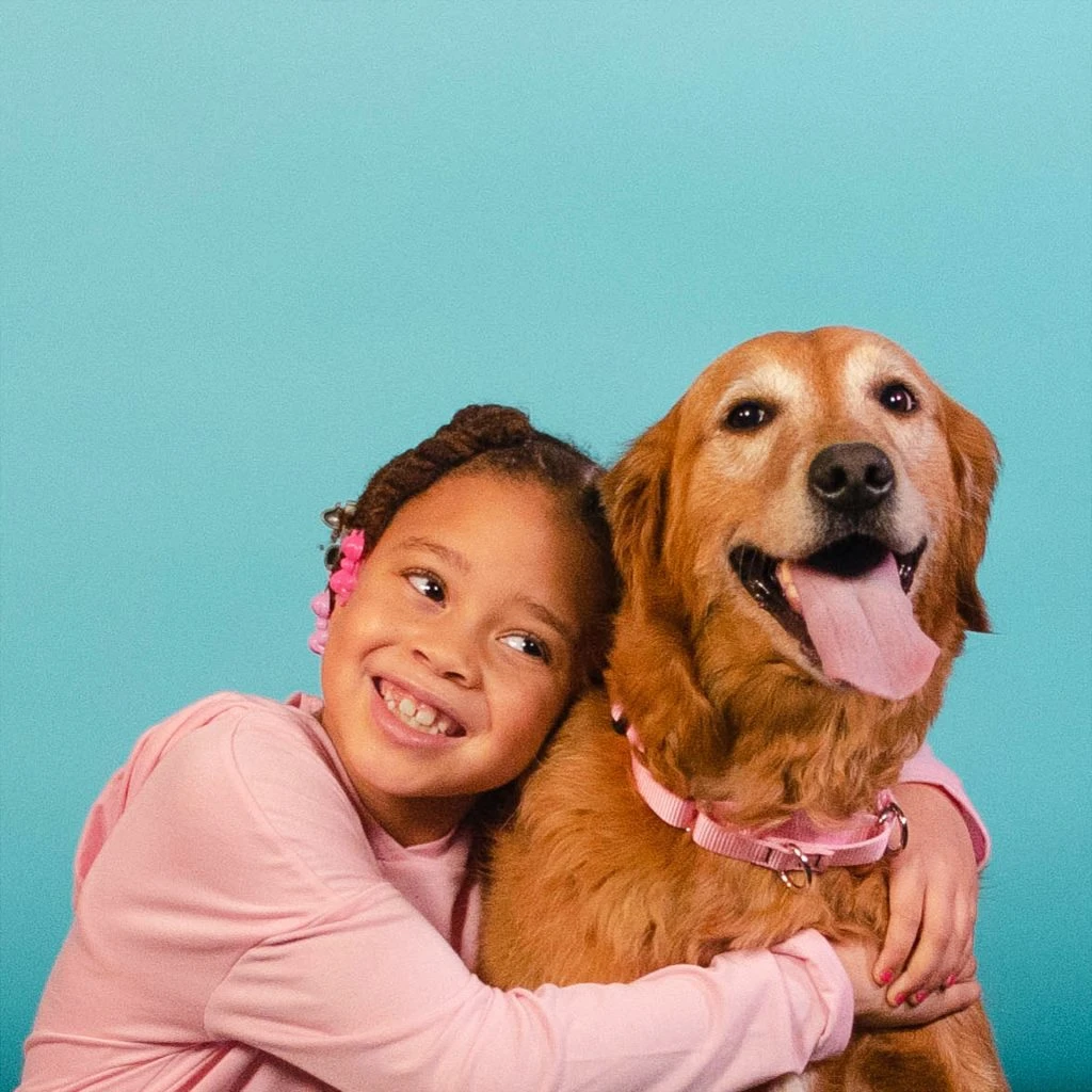 girl hugging dog