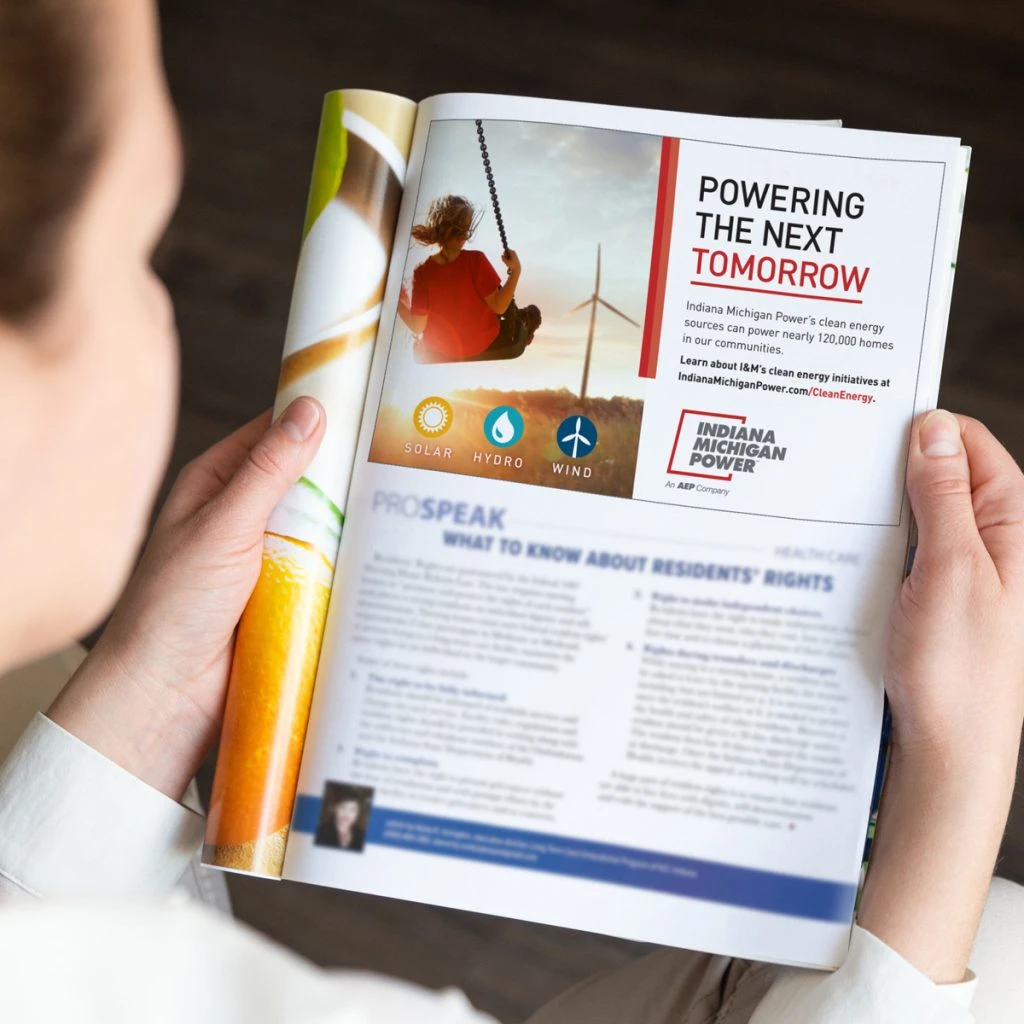 person reading Indiana Michigan Power print report