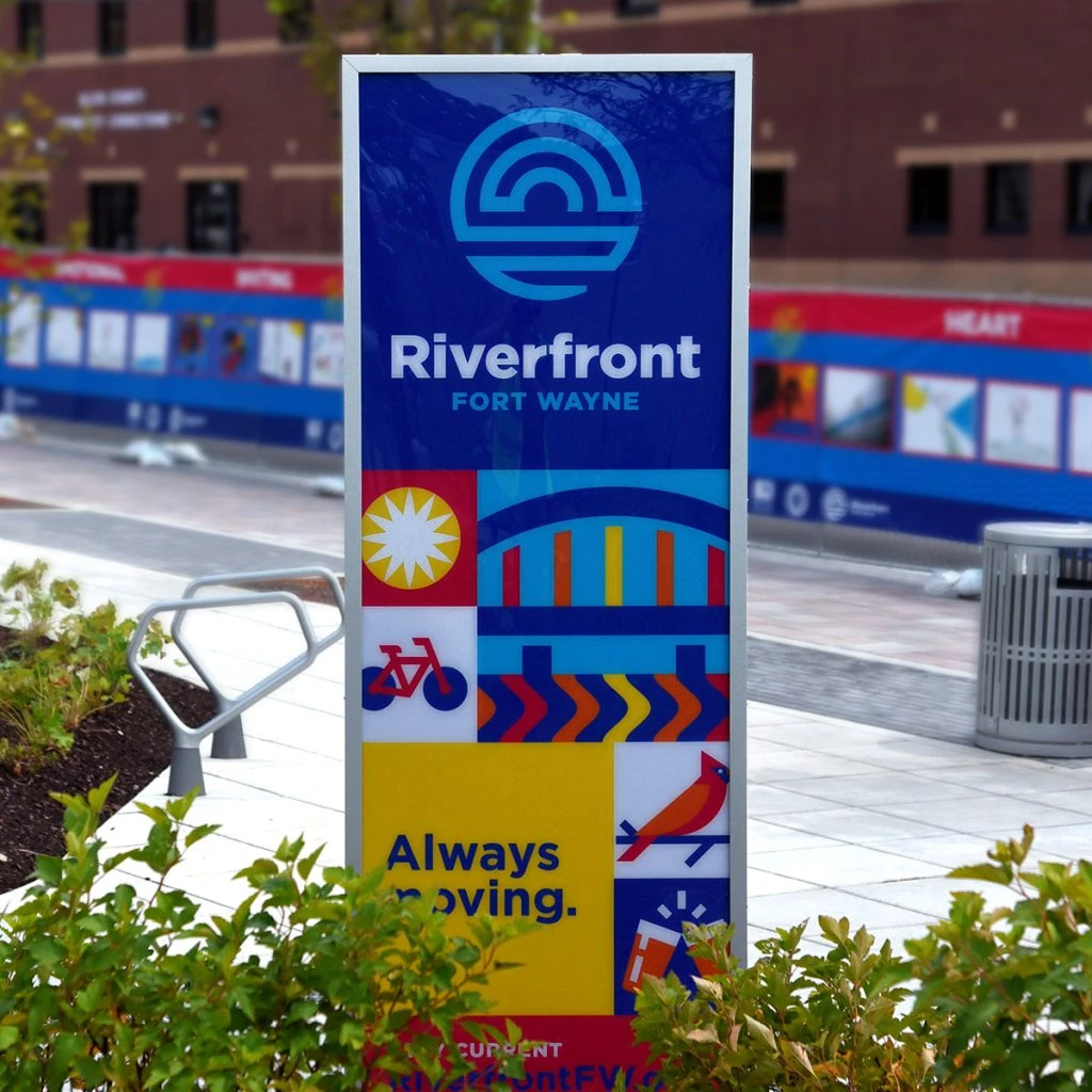 Riverfront Fort Wayne signage in a park