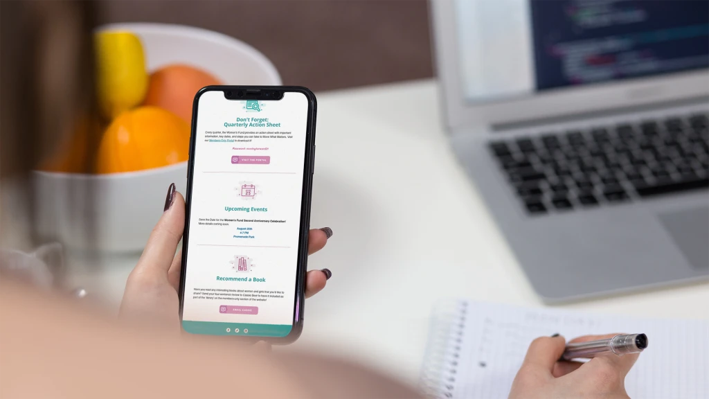 Woman holding phone taking notes