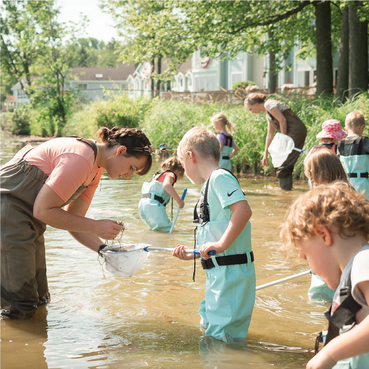 Group of children leaning about water quality with teachers