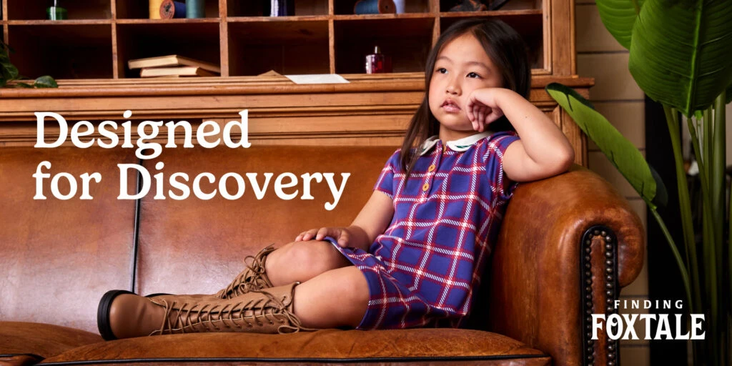 "Designed for Discovery" on styled photo of child in Finding Foxtail attire.