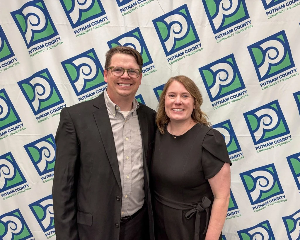 Photo of Putnam County Community Foundation staff posing in front of a branded backdrop.
