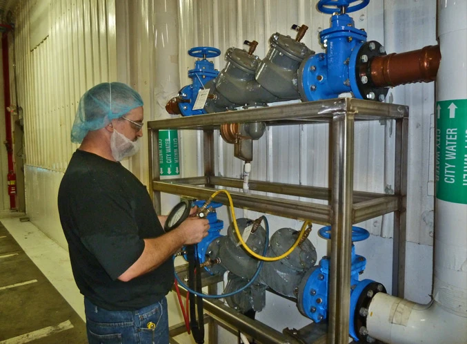 Pena's Mechanical Pipefitter performing an inspection of a Backflow Preventer