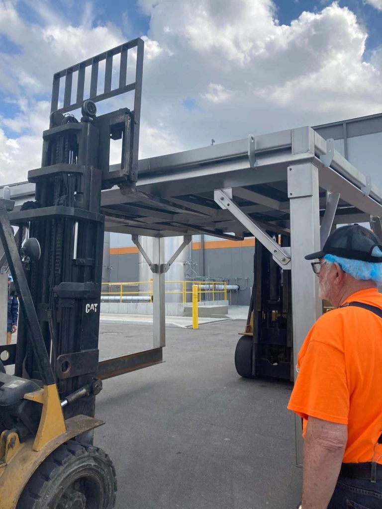 Peña's Mechanical Contractors using a forklift and rigging equipment for a mezzanine for installation