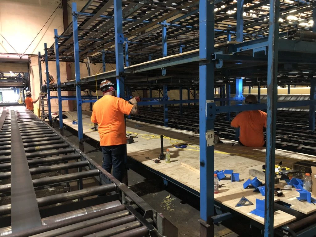 Pena's Mechanical Contractors assembling and installing custom material handling systems-large scale storage rack