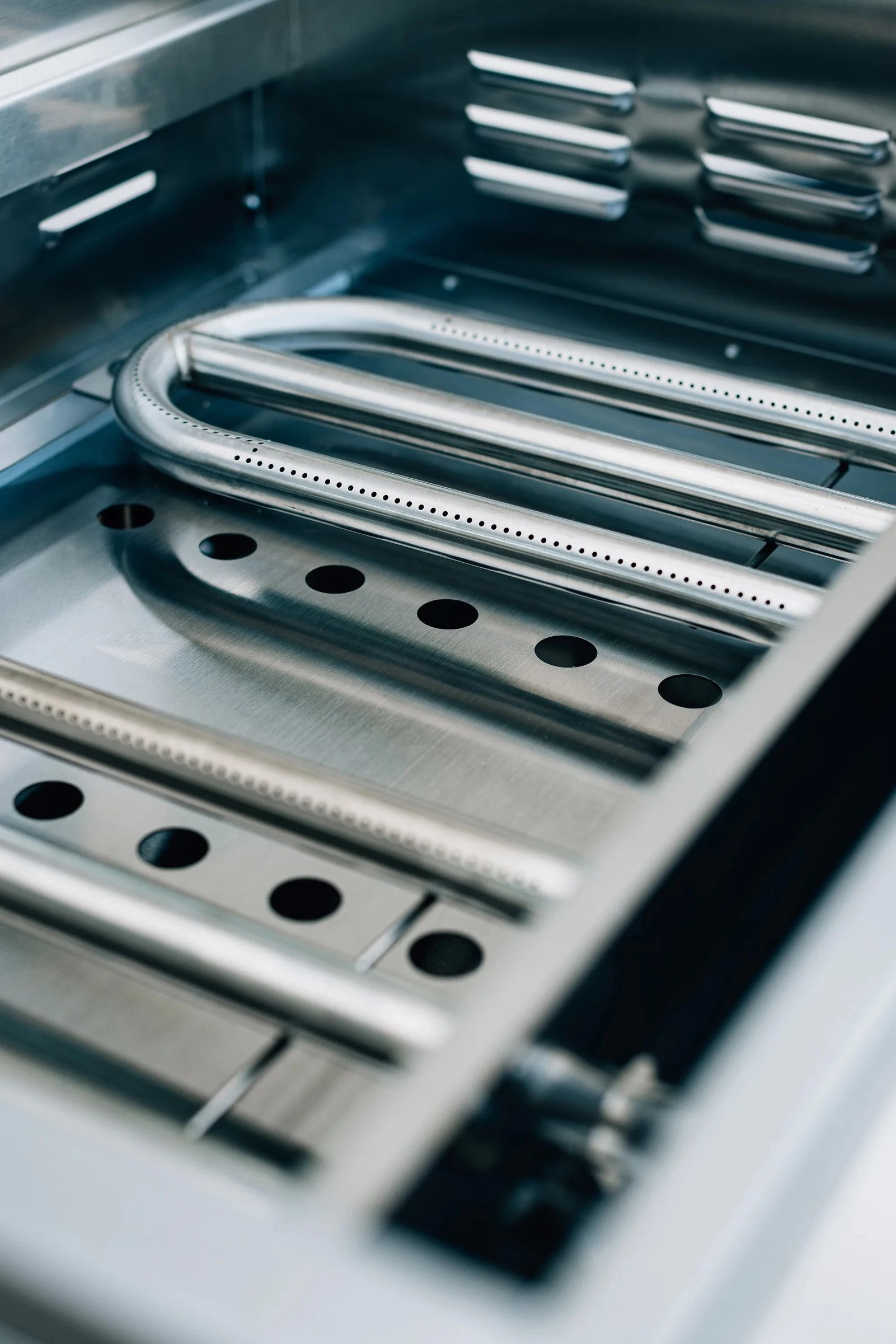 Firebox interior of the Summerset 30-inch Griddle Pro built-in gas griddle with the U-tube burner installed beneath the cooking surface