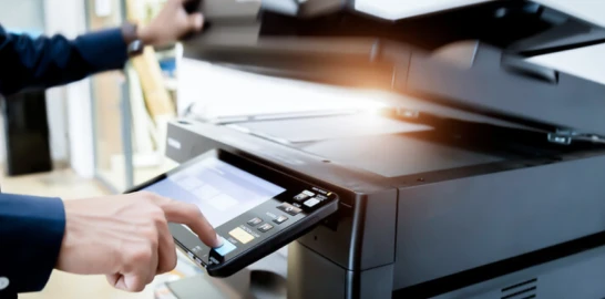 hand operating a copy machine